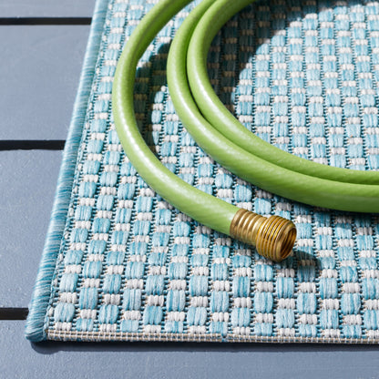 Tapis de patio/jardin imperméable SAFAVIEH Courtyard Begajeta pour intérieur/extérieur.