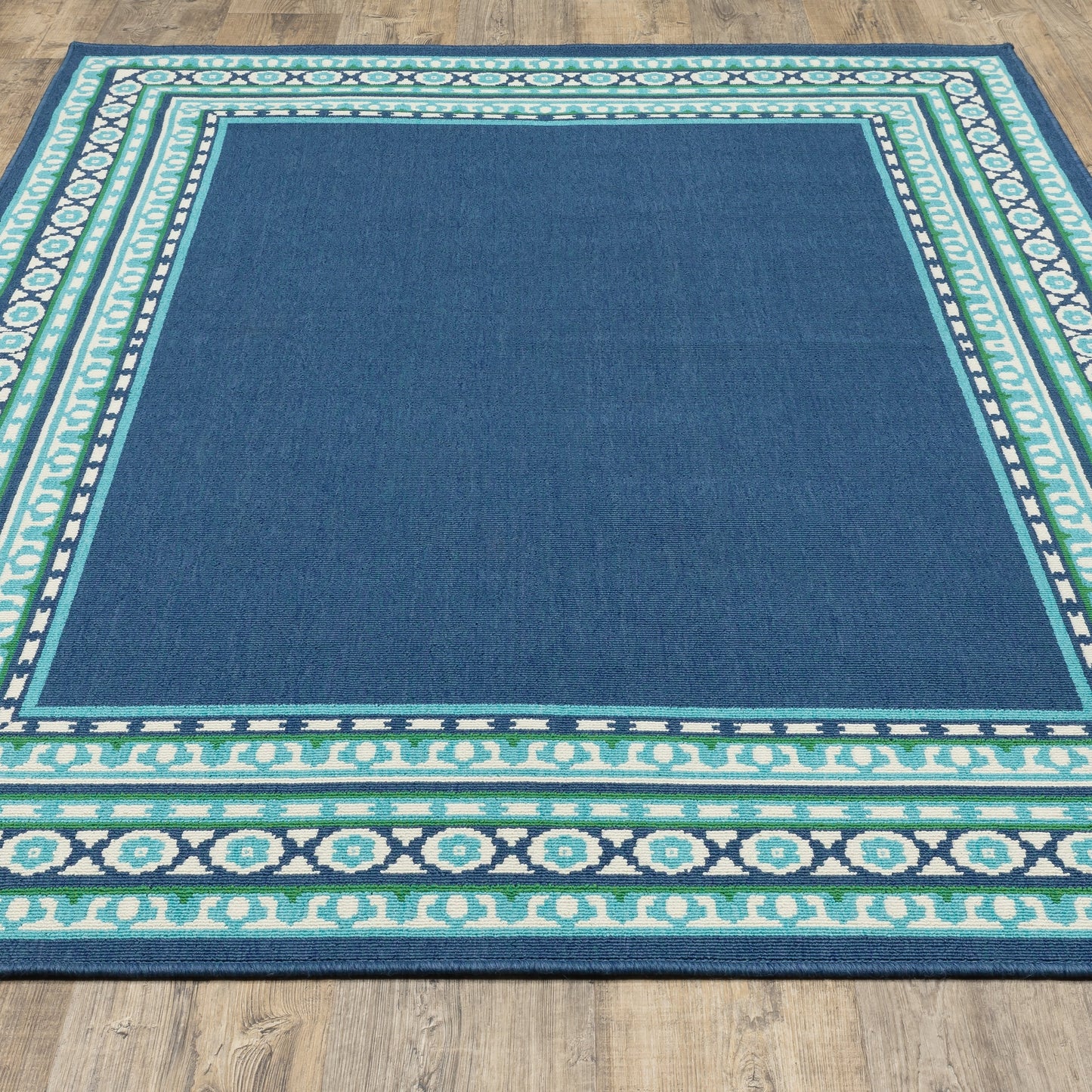 Tapis d'intérieur/extérieur Style Haven Martinque Green à bordure marine~